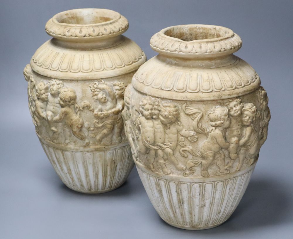 A pair of 19th century earthenware vases relief moulded in Italian Renaissance style, 30cm